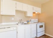 Thumbnail 16 of 22 - a kitchen with white appliances and white cabinets