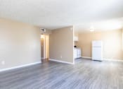 Thumbnail 19 of 22 - an empty living room and kitchen with a refrigerator and