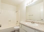 Thumbnail 14 of 22 - a bathroom with a sink toilet and shower and a mirror