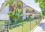 Thumbnail 1 of 25 - a house with a yard and a fence in front of it