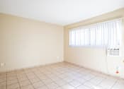 Thumbnail 10 of 25 - an empty room with a window and a tiled floor