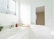 Thumbnail 14 of 25 - a bathroom with a sink and a mirror