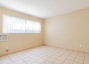 Thumbnail 11 of 25 - an empty room with a window and a tiled floor