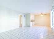 Thumbnail 12 of 25 - an empty living room with a tile floor