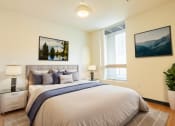 Thumbnail 1 of 15 - a bedroom with a large bed and a window