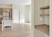 Thumbnail 2 of 107 - A kitchen with a white table and wooden shelves.