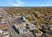 Thumbnail 67 of 107 - A large building with a parking lot in front of it.