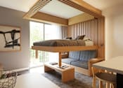 Thumbnail 102 of 107 - A modern bedroom with a canopy bed and a painting on the wall.
