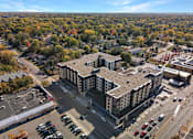 Thumbnail 66 of 107 - A large building with a parking lot in front of it.