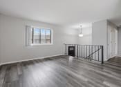 Thumbnail 12 of 13 - an empty living room with hardwood floors and a window