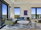 Thumbnail 29 of 107 - A modern living room with a large window and a view of the outdoors.