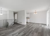 Thumbnail 11 of 13 - the living room and dining room of an apartment with wood flooring