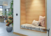 Thumbnail 23 of 107 - A modern room with a wooden panelled wall and a bench with cushions.