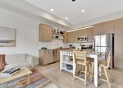 Thumbnail 82 of 107 - A modern kitchen with wooden chairs and a dining table.