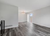 Thumbnail 5 of 13 - a living room with white walls and a sliding glass door