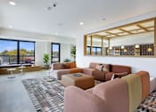 Thumbnail 50 of 107 - A living room with a large window and a view of trees outside.