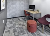Thumbnail 45 of 107 - A small office with a desk, chair, and trash can.