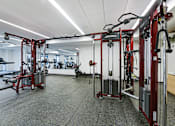Thumbnail 21 of 107 - A gym with a variety of equipment including a weight bench and a leg press machine.