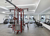 Thumbnail 18 of 107 - A gym with a variety of equipment including a leg press machine.