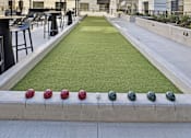 Thumbnail 8 of 107 - A miniature golf course is located in the courtyard of a modern apartment complex.