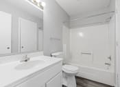 Thumbnail 9 of 13 - a bathroom with a sink and a toilet and a shower