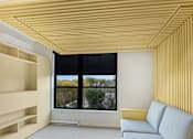 Thumbnail 98 of 107 - A modern living room with a yellow couch and a large window.