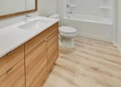 Thumbnail 87 of 107 - A white toilet sits under a mirror in a bathroom.