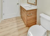 Thumbnail 86 of 107 - A white toilet sits next to a sink in a bathroom.