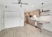 Thumbnail 52 of 107 - A modern kitchen with a fan on the ceiling.