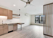 Thumbnail 60 of 107 - A modern kitchen with wooden cabinets and a ceiling fan.