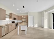 Thumbnail 92 of 107 - A modern kitchen with a dining table and chairs.