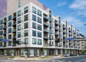Thumbnail 1 of 24 - a large apartment building on the corner of a city street