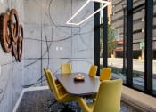 Thumbnail 9 of 24 - a dining room with yellow chairs and a table and large windows