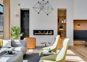 Thumbnail 13 of 24 - a living room with a couch and chairs and a fireplace