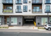Thumbnail 12 of 24 - the entrance to a building with a car parked in front of it