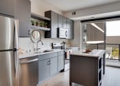 Thumbnail 15 of 24 - a modern kitchen with stainless steel appliances and a counter top