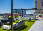 Thumbnail 8 of 24 - a roof top patio with tables and chairs and a view of the city