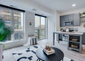 Thumbnail 18 of 24 - an open living room with a kitchen and a large window