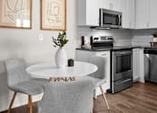 Thumbnail 19 of 53 - a kitchen and dining area in a 555 waverly unit