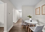 Thumbnail 24 of 53 - a dining area with a round table and three chairs