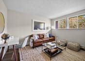 Thumbnail 10 of 53 - a living room with a brown couch and a glass coffee table
