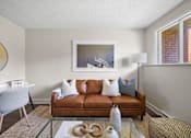 Thumbnail 14 of 53 - a living room with a brown couch and a glass coffee table