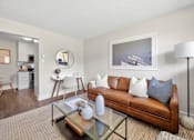 Thumbnail 11 of 53 - a living room with a brown couch and a glass coffee table
