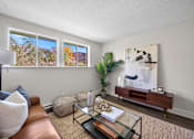 Thumbnail 9 of 53 - a living room with a glass coffee table and brown couch