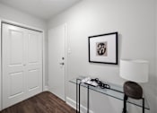 Thumbnail 51 of 53 - a bedroom with white walls and a glass table with a lamp on it