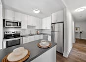Thumbnail 43 of 53 - a kitchen with white cabinets and stainless steel appliances