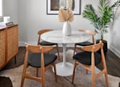 Thumbnail 35 of 53 - a dining room with a round table and four chairs