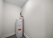 Thumbnail 28 of 53 - a room with a water heater and a white wall