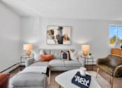 Thumbnail 40 of 53 - a living room with a gray couch and a white coffee table