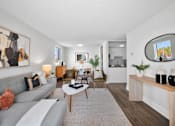 Thumbnail 38 of 53 - a living room with a gray couch and a white coffee table